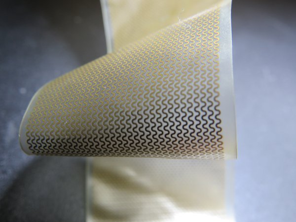 Stretchable PCB prototype with serpentine copper traces on flexible polyimide substrate